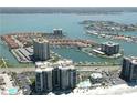 Wide aerial showcasing waterfront community, building, and beach access at 1651 Sand Key Estates Ct # 66, Clearwater Beach, FL 33767