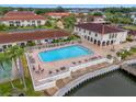 Community pool with ample deck space and waterfront access at 19029 Us Highway 19 N # 13F, Clearwater, FL 33764