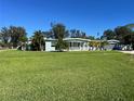 Ranch style home with lush green lawn and mature trees at 205 81St Ne Ave, St Petersburg, FL 33702