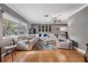Bright living room with hardwood floors and a large sectional sofa at 2240 Colonial Dr, Dunedin, FL 34698