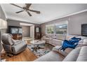 Spacious living room featuring hardwood floors and comfortable seating at 2240 Colonial Dr, Dunedin, FL 34698