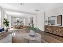 Open-concept living and dining area with wood floors and modern decor throughout the spacious layout at 2729 36Th N Ave, St Petersburg, FL 33713