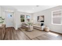 Bright living room boasts neutral tones, stylish decor, wood floors, and abundant natural light at 2729 36Th N Ave, St Petersburg, FL 33713