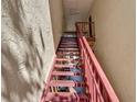 Indoor condo stairwell with red railings at 3869 S Lake Dr # 146, Tampa, FL 33614
