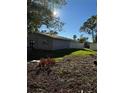 Side yard with new landscaping and a partially visible fence at 5811 Venetian Ne Blvd, St Petersburg, FL 33703