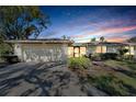 Evening view of a single-story house with a two-car garage at 1510 Ingram Dr, Sun City Center, FL 33573