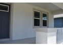 Close-up of the covered entry featuring new windows and neutral tones at 2735 36Th N Ave, St Petersburg, FL 33713