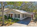 White brick home with carport and fenced yard at 3214 W Villa Rosa St, Tampa, FL 33611