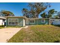 Single-story home with light green exterior and a spacious lawn at 4211 Shore Acres Ne Blvd, St Petersburg, FL 33703