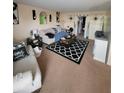 Living room with comfy seating and patterned rug at 4880 Locust Ne St # 234, St Petersburg, FL 33703