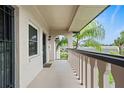 Covered balcony with a view of tropical landscaping at 1403 Cordova Grn, Seminole, FL 33777