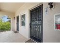 Condo entry with two doors, security bars, and a shared hallway at 1403 Cordova Grn, Seminole, FL 33777