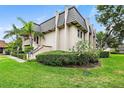 Side view of a condo unit showcasing its architectural details and landscaping at 1403 Cordova Grn, Seminole, FL 33777