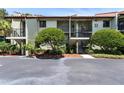 Two-story building exterior with landscaping and parking at 1515 Pinellas Bayway S # 45, St Petersburg, FL 33715
