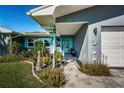 Quaint home exterior with teal door and walkway at 3875 Mckay Creek Dr, Largo, FL 33770