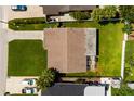 Aerial view of a home with a well-maintained roof, lush green lawn, and ample parking space with long driveway at 4510 Helena Ne St, St Petersburg, FL 33703