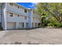 Rear view of light blue building with garages and parking at 4863 W Flamingo Rd Rd # 2, Tampa, FL 33611