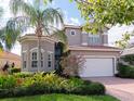 Two story home with a landscaped yard and a two car garage at 5011 Sandy Brook Cir, Wimauma, FL 33598