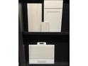 Selection of kitchen cabinet and countertop options in white and gray at 6054 Sawgrass Lake Ct, Nokomis, FL 34275