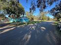 Charming light blue house with a spacious yard and mature trees at 6928 E 29Th Ave, Tampa, FL 33619