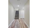Basement hallway with wood-look flooring and storage at 4522 Bay Spring Ct, Tampa, FL 33611