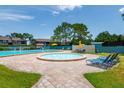 Community pool with a separate spa and lounge chairs at 11486 Bay Ne St # 11486, St Petersburg, FL 33716