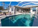 Relaxing pool with screened enclosure and patio furniture at 4121 70Th Street E Cir, Palmetto, FL 34221