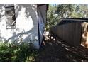 Side yard with a wooden fence and landscaping at 432 2Nd Ne Ave, Largo, FL 33770