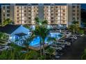 Night view of condo pool, spa, and parking area at 1200 Country Club Dr # 3204, Largo, FL 33771
