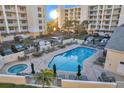 Resort-style pool and jacuzzi with ample seating at this beautiful condominium complex at 1200 Country Club Dr # 3204, Largo, FL 33771