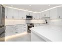 Modern white kitchen with stainless steel appliances and quartz countertops at 1400 Gulf Blvd # 801, Clearwater Beach, FL 33767