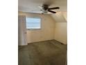 Simple bedroom with ceiling fan and neutral carpeting at 14303 14Th St, Dade City, FL 33523