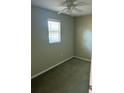 Small bedroom with ceiling fan and neutral walls at 14303 14Th St, Dade City, FL 33523
