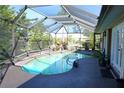 Relaxing kidney-shaped pool with a screened enclosure at 1727 Coco Palm Cir, Sun City Center, FL 33573