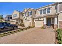 Townhome building showcasing a paved driveway and neatly maintained landscaping at 18843 Ulmus St, Lutz, FL 33558