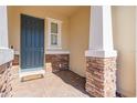 Inviting entryway with a dark blue front door, stone accents and a brick walkway at 18843 Ulmus St, Lutz, FL 33558