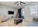 Spacious living room with tile flooring, a comfy seating area and a view to the backyard at 18843 Ulmus St, Lutz, FL 33558