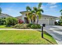 Stunning curb appeal with lush landscaping and paver driveway at 5316 Loon Nest Ct, Apollo Beach, FL 33572