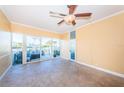 Bright living room with tiled floors, ceiling fan, and sliding glass doors leading to outdoor space at 7400 Sun Island S Dr # 104, South Pasadena, FL 33707