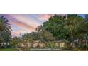 Back view of the house with sunset in the background at 808 Monterey Ne Blvd, St Petersburg, FL 33704