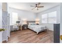 Bright bedroom with wood flooring, neutral decor, and a workspace at 8601 Sandy Plains Dr, Riverview, FL 33578