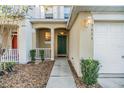 Townhome entryway with green door and landscaped walkway at 9621 Carlsdale Dr, Riverview, FL 33578