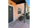 Exterior view of building entrance with a dark door and landscaping at 12404 Orange Blossom Oak Pl # 101, Tampa, FL 33612