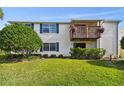 Condo building with balcony and grassy area at 129 Camphor Cir # F, Oldsmar, FL 34677