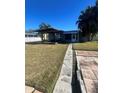 Covered patio and a spacious grassy backyard at 2215 Riomar Dr, Holiday, FL 34691