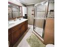 Clean bathroom with double vanity and a walk-in shower at 2912 W Main St, Tampa, FL 33607