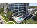 Luxury condo building with pool and lush landscaping at 2912 W Santiago St # 404, Tampa, FL 33629