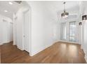 Light-filled hallway with light hardwood floors and neutral paint at 34 Concord Dr, Dunedin, FL 34698