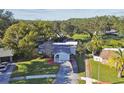 Single story home situated on a large lot with lush landscaping at 918 Windward Way, Palm Harbor, FL 34685