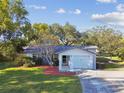 Charming ranch home with a well-manicured lawn and attached garage at 918 Windward Way, Palm Harbor, FL 34685